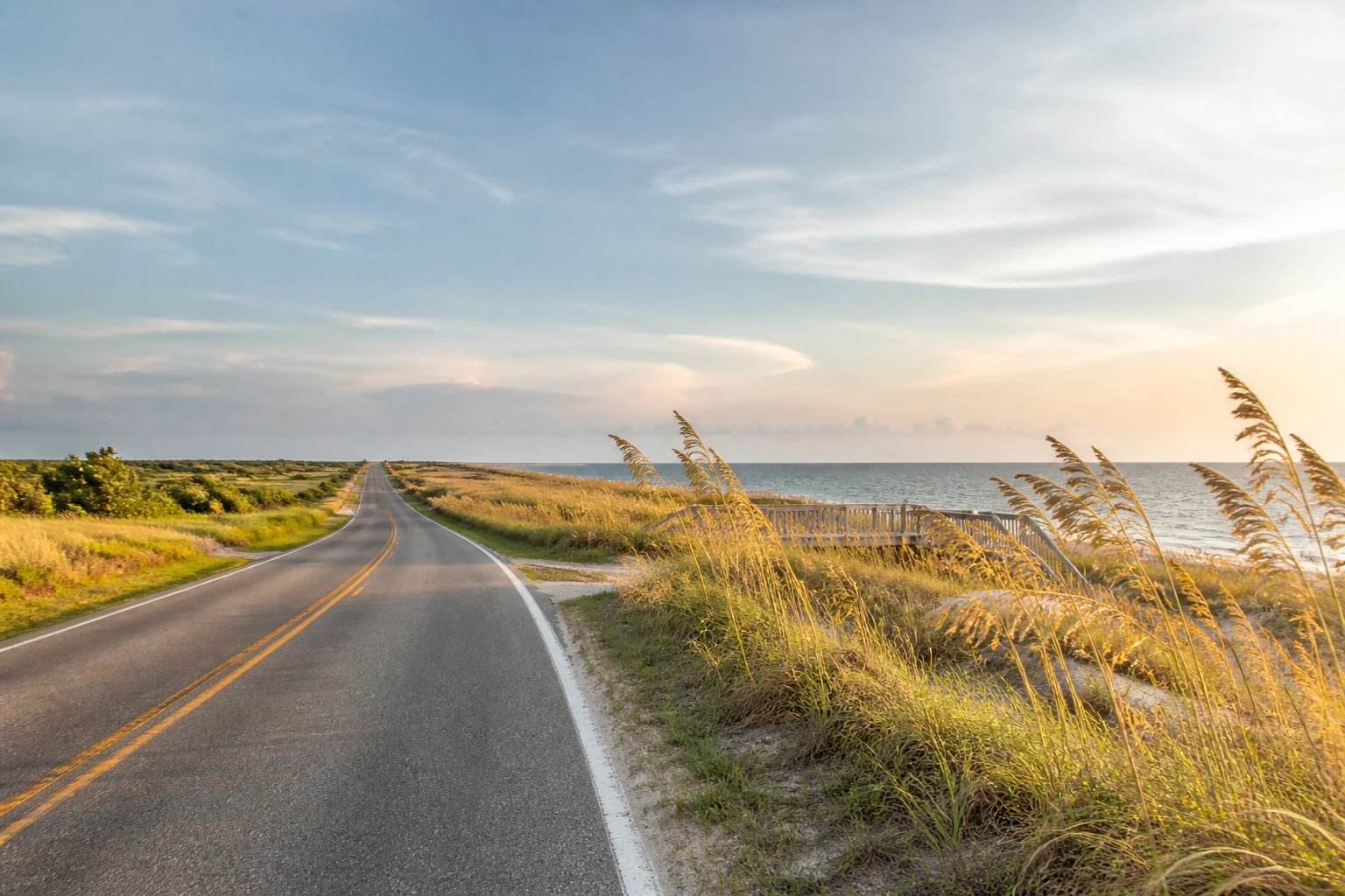 A luminous coastal road curving beside the water